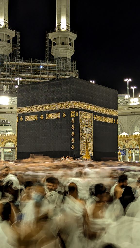 A long exposure shot of pilgrims performing Tawaf at the Kaaba during night, in the holy city of Mecca.